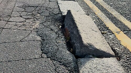 A damaged kerb stone on Higham Hill Road